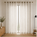 A pair of Pearl white textured grommet curtains hanging on a gold curtain rod in a bright, modern room setting.
