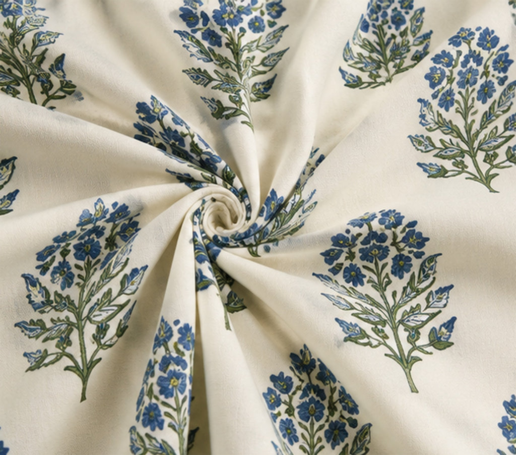 Floral patterned fabric with blue and green flowers on a cream background