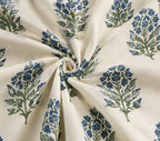 Floral patterned fabric with blue and green flowers on a cream background