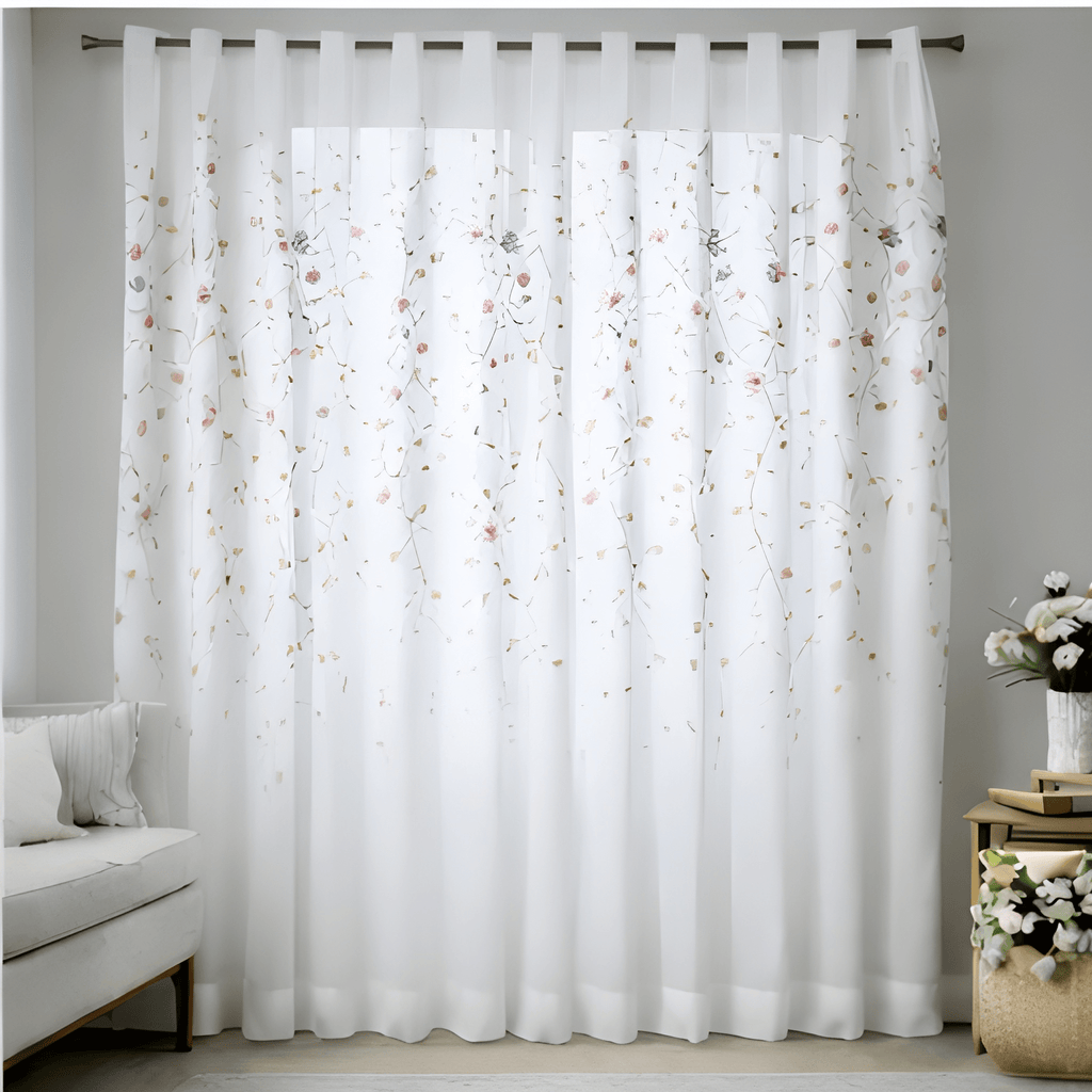 Sheer white curtain with floral pattern in a room with a sofa and decorative items.