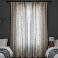 Patterned curtains in a bedroom setting with dark walls and bedding.