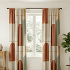 Pair of geometric patterned curtains hanging in front of a window with a plant and side table in the background.